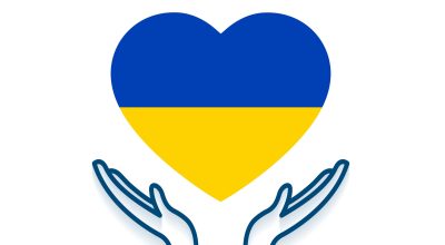 care hands with ukraine flag in heart shape